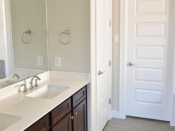 The double vanity with plenty of cabinet space is conveniently next to the large walk in closet