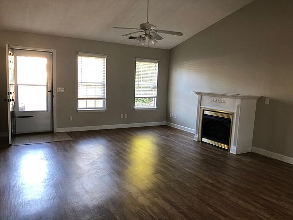 living room - gas logs - LVT plank flooring- vaulted ceiling