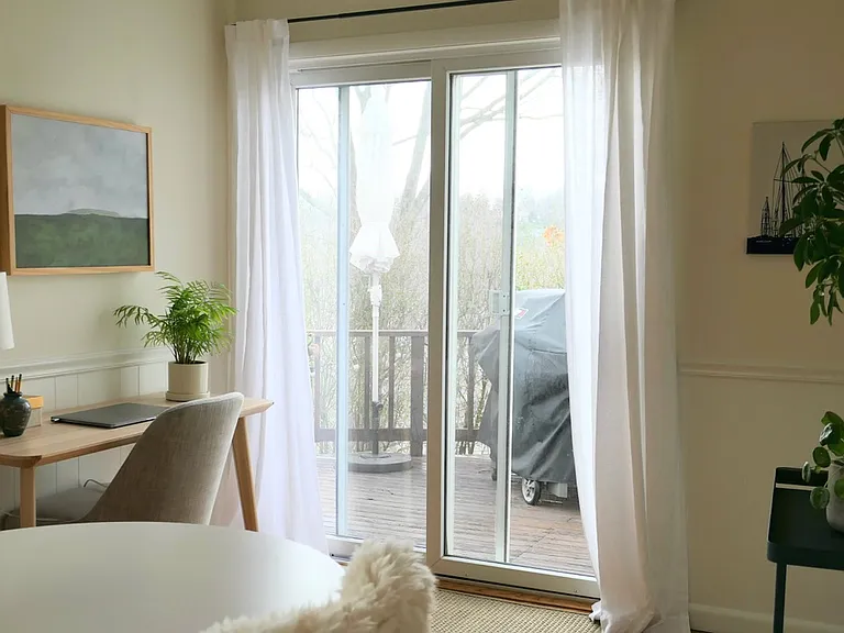Sliding doors from dining room to side yard deck.