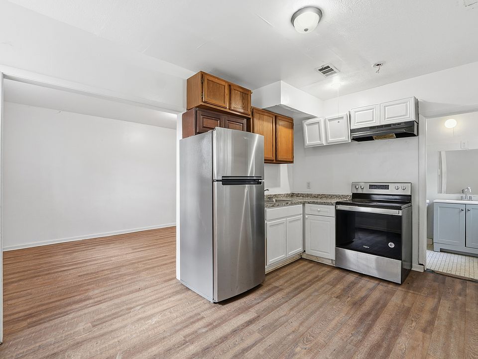 The lower level features a separate studio-style suite with its own full bathroom, kitchen, and private entrance ideal for a guest suite, home office, or bonus living space.