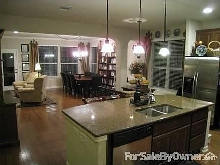 Kitchen/ Breakfast/ Family room
						:
						This area is very flexible and open;window seat in breakfast, stone FP surround.