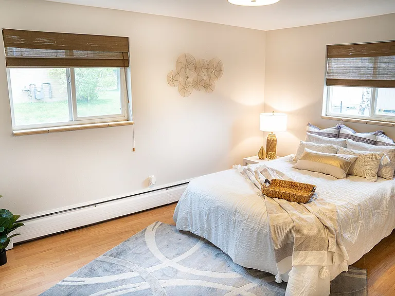 Inviting bedroom with soft lighting, modern decor, and cozy bed for ultimate relaxation.