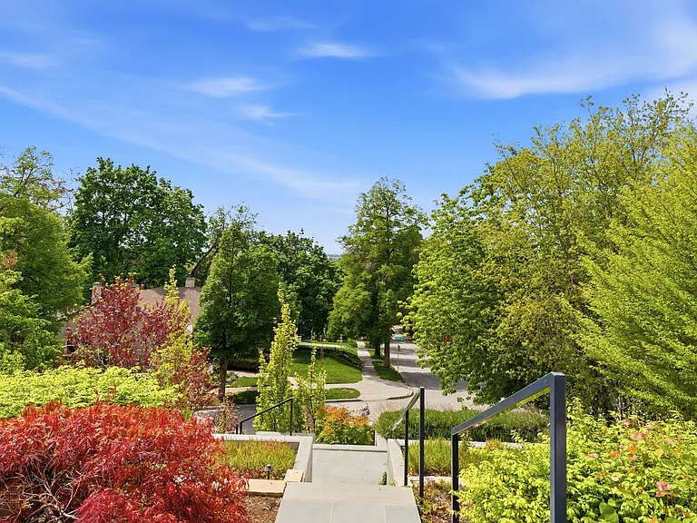 Front walkway from the street. There is also a covered private tunnel from the 2 garages directly to the lower level of the house.