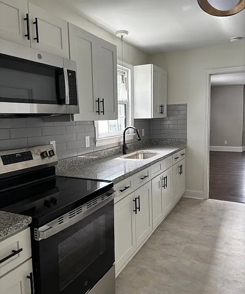 Completely Remodeled Kitchen, new floor, new stove and new microwave.