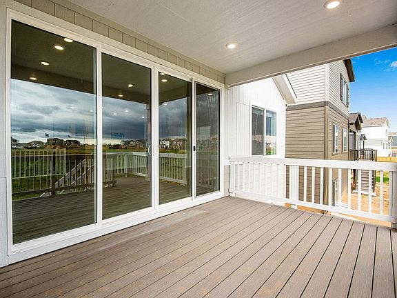 Rear exterior with covered patio and sliding doors to great room