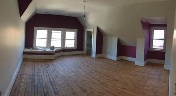 Large living room with multiple alcoves, closet and outside