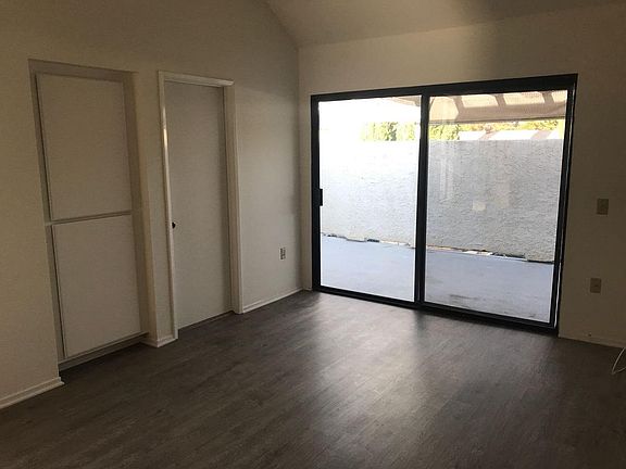 BEDROOM WITH ATTACHED PATIO AND WALK IN CLOSET
