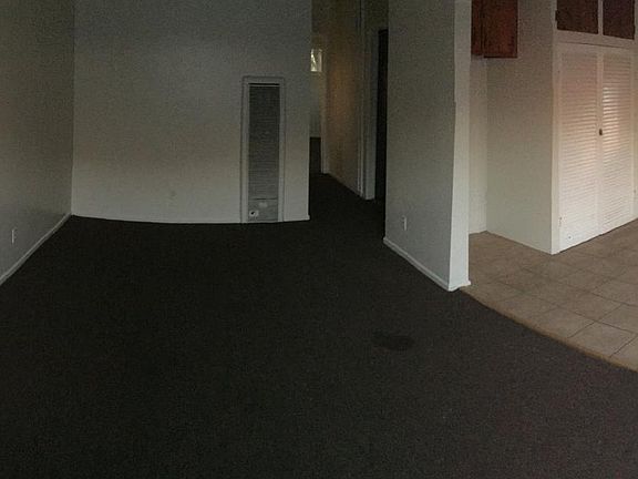 180 view of the front door, living room, hallway and kitchen. CARPET WILL be taken out and replaced by Laminate Flooring.