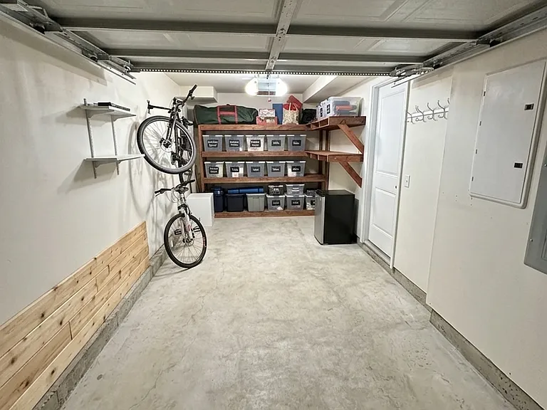 one car garage with sheives and bike rack
