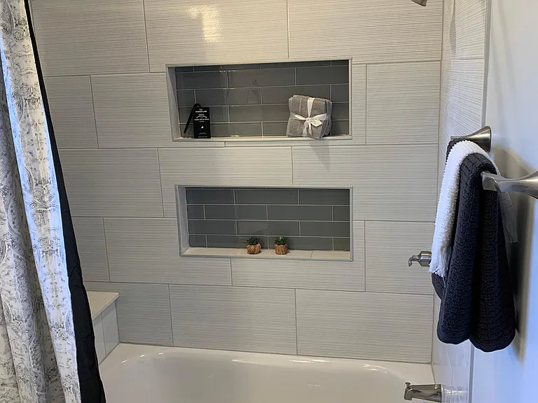 GUEST BATH SHOWER WITH NICHE AND TILE SURROUND