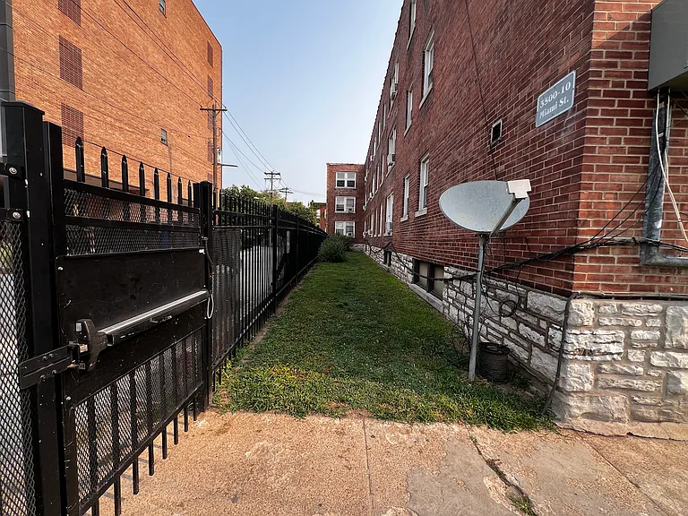 Area on side of building for only dogs with courteous owners who pick up their poop.