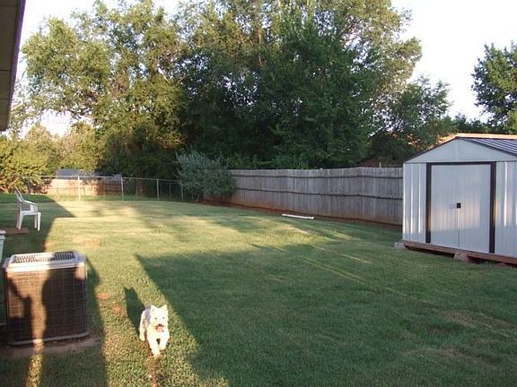 Large, fenced-in backyard (storage building)
