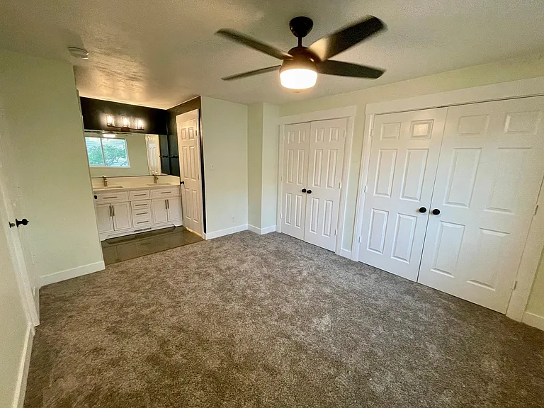 Primary suite with double closets. Sliding doorways upgraded to swinging doors for easy access to full closet.