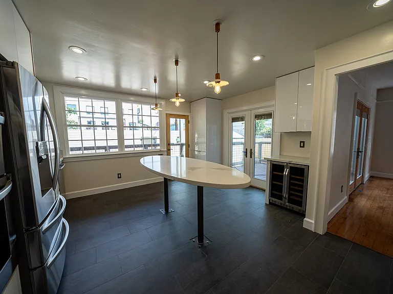 Kitchen showing wine fridge and exits to deck 1 and deck 2