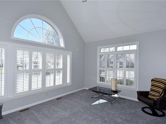 A gorgeous arched window is showcased in the living room along with neutral tones that will match any dcor.