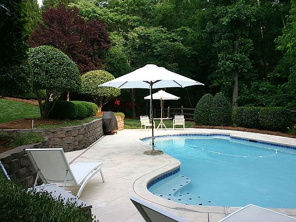 Pool Level View/Deep Backyard continues beyond fence into wooded area