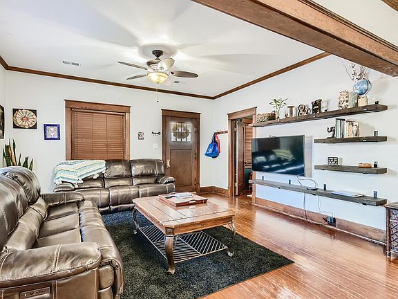 Living room, looking to front door and first bedroom.