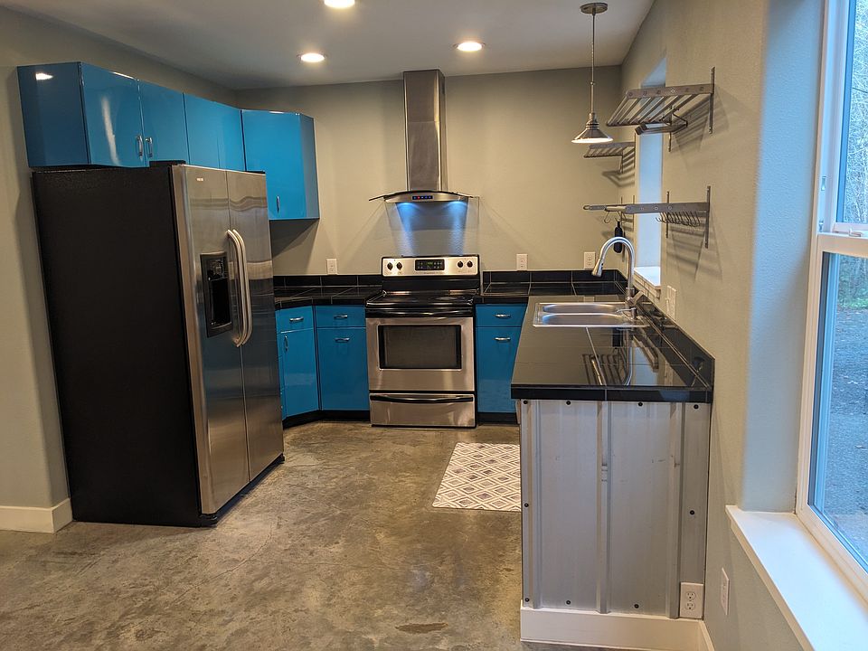 Nice modern kitchen with large refrigerator, range/oven, dishwasher and microwave/air fryer.