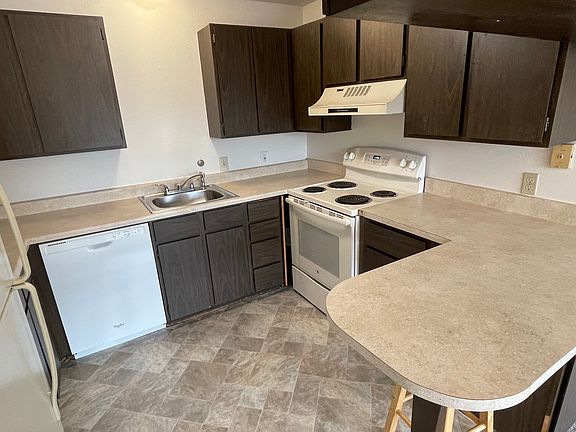 Large kitchen with dishwasher and breakfast bar.