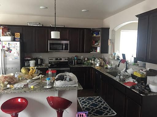 (Pls. pardon the clutter) Another view of the kitchen island, counter tops cabinets and appliances