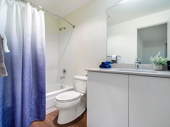 Renovated III bathroom with white cabinetry, grey quartz countertops, and hard surface flooring