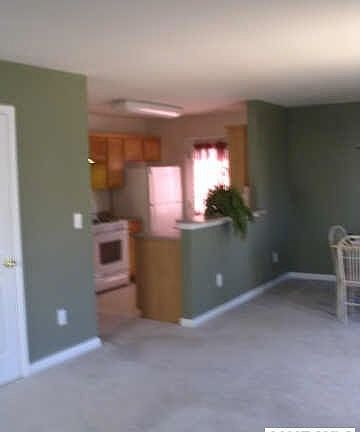 Galley style kitchen that is open and sunny