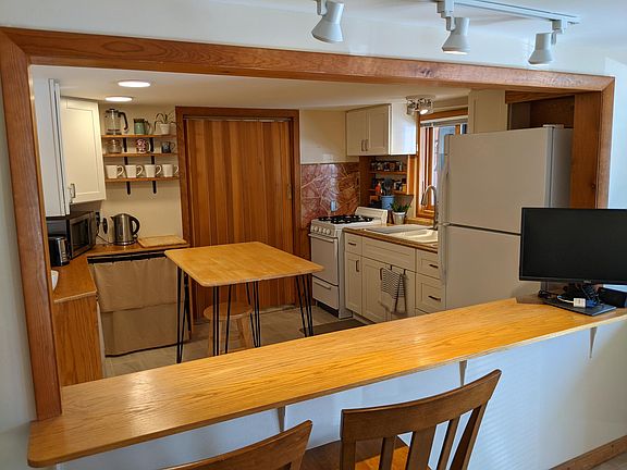 Kitchen view through open bar from Living room