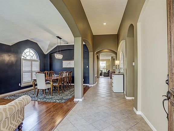 Step inside to discover raised ceilings, decorator paint, wonderful natural light from scattered windows, and arched doorways.