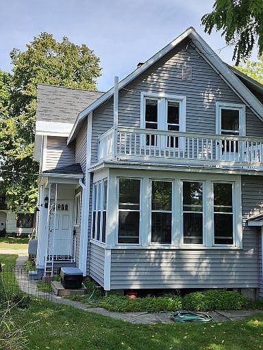 Exterior entry on lower left, upper walk out shown above. Vinyl siding, well kept.