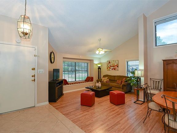 16x12 Living Room - All seats will offer a good view of the movie or the game. Wood laminate floors, vaulted ceiling and ceiling fan add finishing touches.