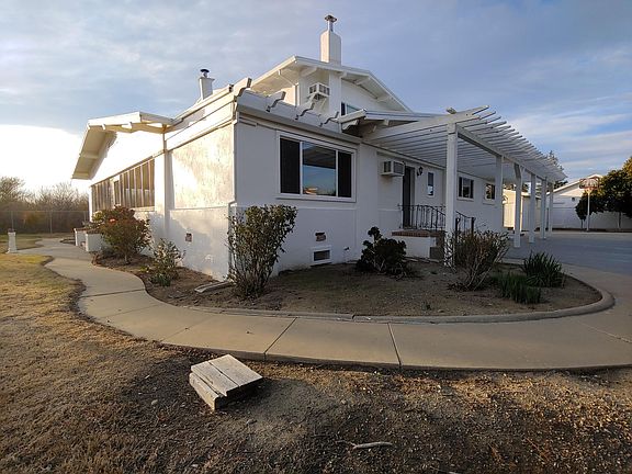Sidewalk rounds sunporch and main entry.