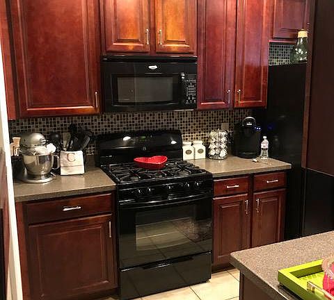 1st Floor Kitchen - Gas stove, microwave, refrigerator side by side