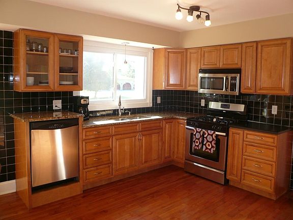 Remodeled kitchen features granite countertops, stainless steel appliances and hardwood flooring.