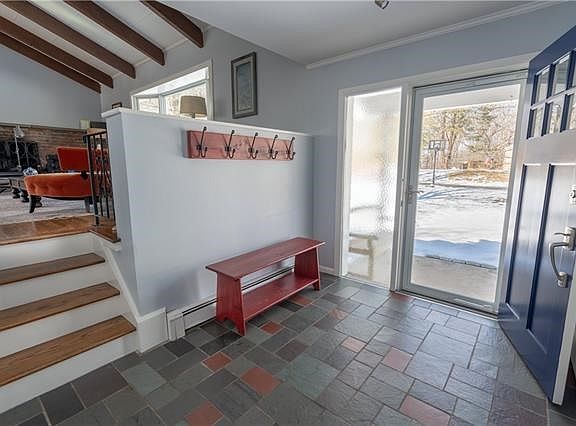 Behind the blue front door is the spacious entry hall with a coat closet.