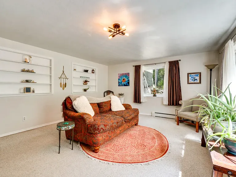 Lower Garden level living room 2nd living area with plenty of light, large windows. Decorated with fine furnishings and art decor