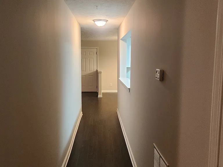 Hallway connecting the front of the condominium and the rooms in the back