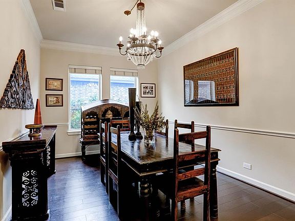 The Formal Dining Room has a designer chandelier, crown and chair molding, hardwood floors and plenty or room to expand a table for entertaining or family holidays.