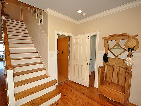 Entry hall with bead board wainscot which is found throughout the home. Wood paneled elevator is acc
