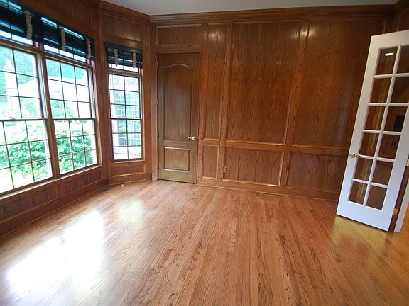 Library: hardwood fl, built-in shelves, closet, recessed lights, crown molding
