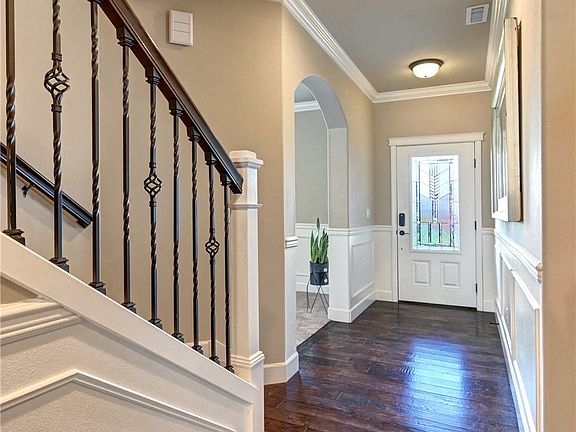 Entry features beautiful door with lead glass and extensive millwork.