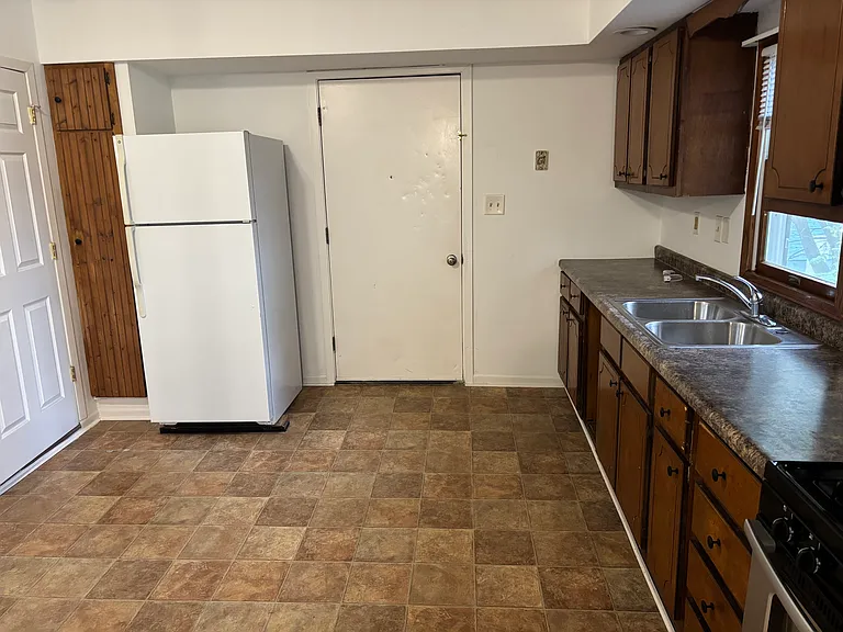 kitchen and dining room space to the left. Pantry next to refrigirator.