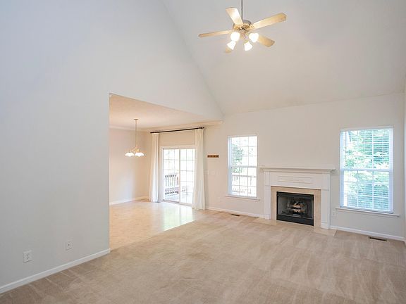 Living room, dining room, and kitchen. The doors in the dining room open to the deck.