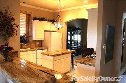 Kitchen : Granite countertops, spacious island w/ cabinets, dual dishwasher, tile floors.