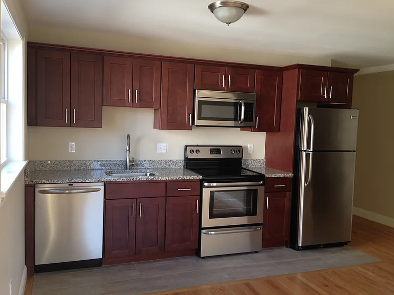 Kitchen with stainless steel appliances and granite countertops.
