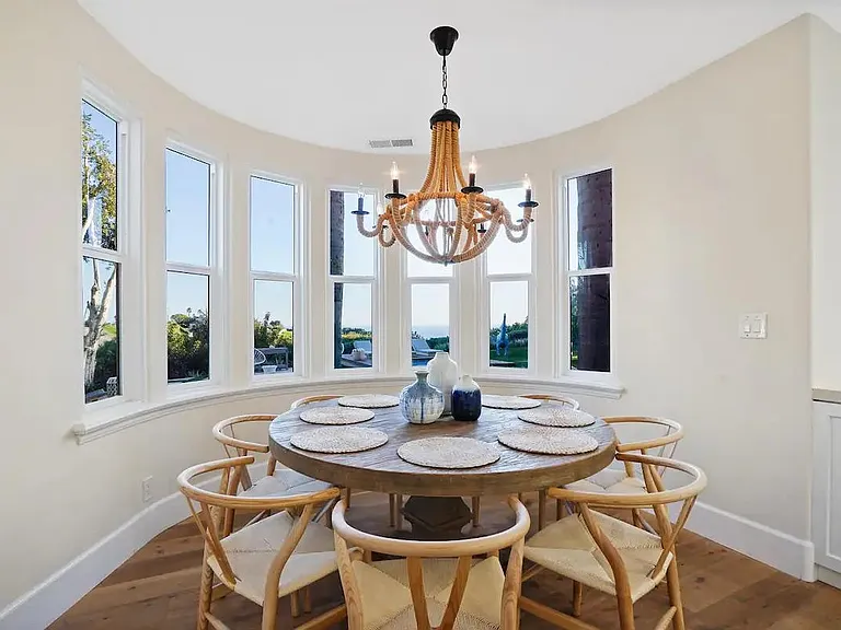 A charming dining area overlooking the luxurious backyard area.