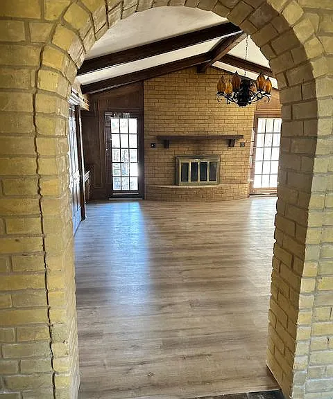 Stylish brick arches frame the view into the living room.