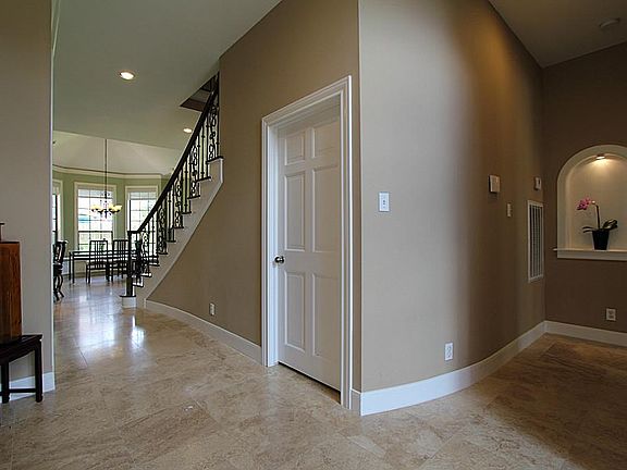 View from entrance toward kitchen and breakfast room. Right hallway leads to master bedroom.