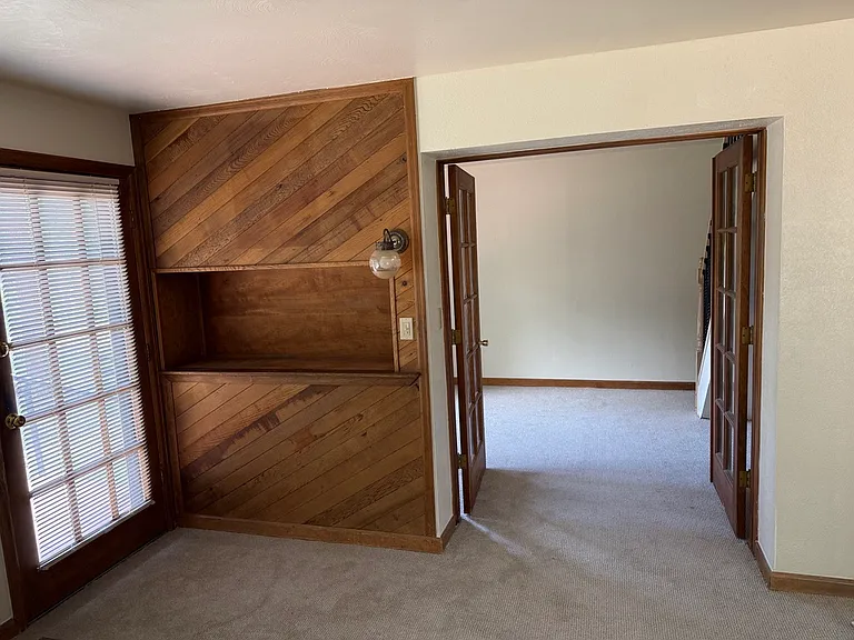entertainment shelf and entrance to den/office