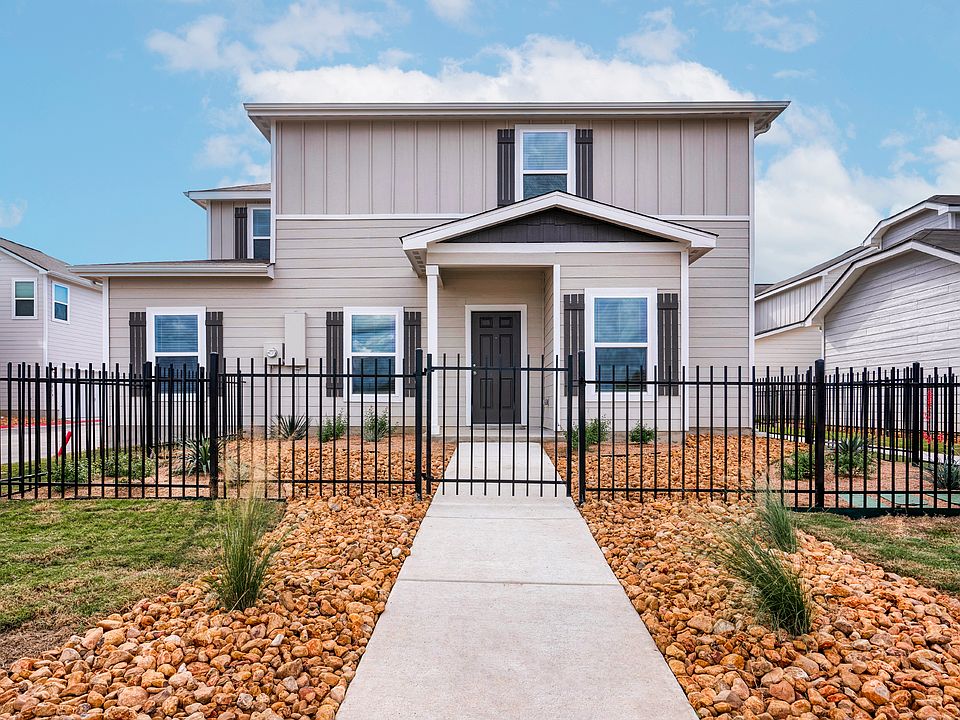 Exterior of the stunning Halpert plan with professional front yard landscaping.