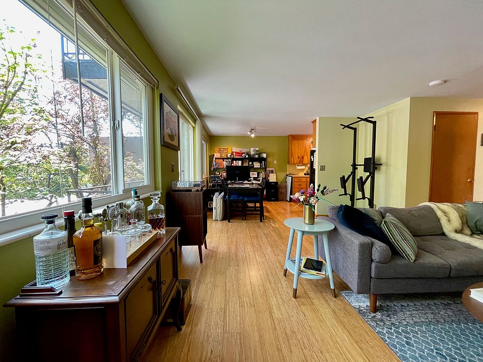 Living and dining areas with great natural light by east-facing windows.